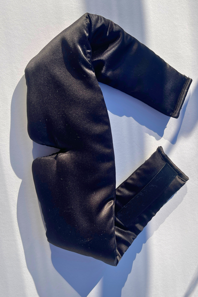 silk sleep mask in black, made with 23 Momme mulberry silk, shown on a neutral background.”