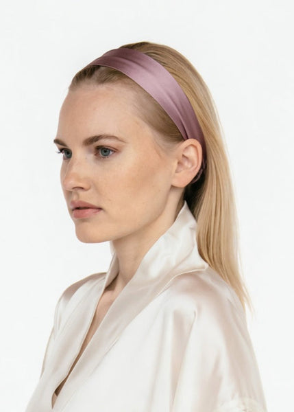 A woman in profile wearing a wide, thin mauve-purple satin headband and a cream satin shirt. The brand name 'KOBAYASHI DESIGN' is printed in white text at the bottom center.